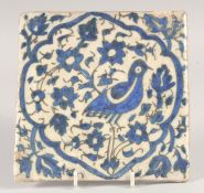 A FINE 18TH CENTURY PERSIAN BLUE AND WHITE GLAZED POTTERY TILE, painted with a bird and floral