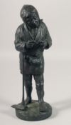 A JAPANESE BRONZE FIGURE OF A MAN HOLDING A PIPE, leaning on a hoe. 12ins high.