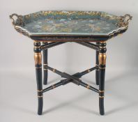 AN ORNATE PORCELAIN TWIN HANDLED TRAY on a gilded ebonised stand. 29ins wide.