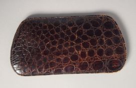AN ASPREYS CROCODILE SKIN SPECTACLE CASE.