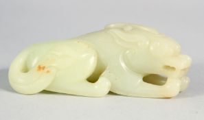 A CHINESE CARVED JADE CROUCHING LION. 9cm long.
