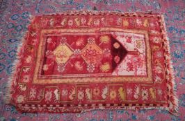 A SMALL PERSIAN RUG, rust ground with stylised decoration. 4'2
