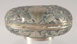 A CHINESE SILVER OVAL BOX with embossed and engraved decoration. 7.5cm.