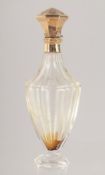 A CUT GLASS SCENT BOTTLE WITH HINGED GOLD TOP. 10cm high