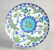A 19TH CENTURY TURKISH OTTOMAN IZNIK PLATE, with foliate decoration, 30.5cm diameter.