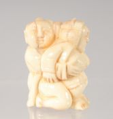 A CHINESE CARVED BONE EROTIC NETSUKE. 4.5cm.