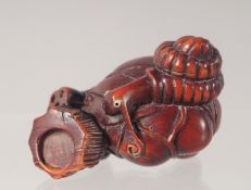 A CARVED WOOD NETSUKE modelled as a dragon 5cm long.
