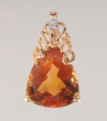 AN 18CT GOLD TOPAZ AND DIAMOND PENDANT.