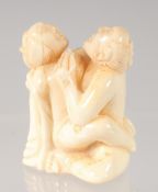 A CHINESE CARVED BONE EROTIC NETSUKE. 4.5cm.