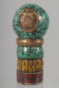 A TIBETAN TURQUOISE AND BRONZE SEAL. 10cm high.