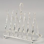 A NOVELTY PLATED TOAST RACK MODELLED AS GOLF CLUBS.
