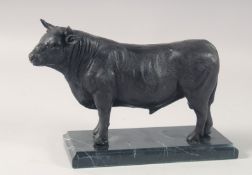 A BRONZE MODEL OF A STANDING BULL on a marble base. 10ins long.
