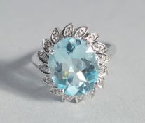 A SILVER AND BLUE TOPAZ AND DIAMOND RING.