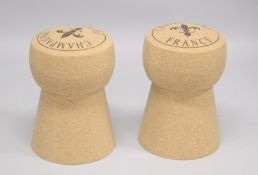 A PAIR OF NOVELTY BAR STOOLS modelled as champagne corks. 1ft 8 ins high.