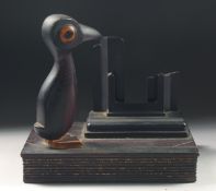 A 1920'S ART DECO BIRD CALENDER STAND WITH CHERRY AMBER / BAKELITE BEAK.