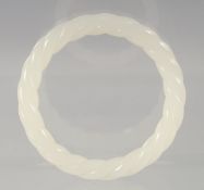 A CHINESE OPAQUE JADE TWISTED BANGLE. 8cm diameter
