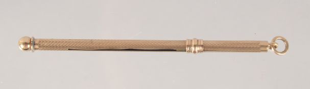 A GOLD SWIZZLE STICK.