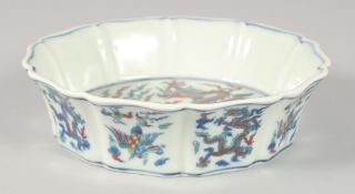 A CHINESE DOUCAI PORCELAIN PETAL FORM BOWL, painted with dragons and phoenix, 17.5cm diameter.