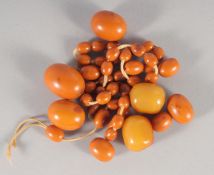 A GROUP OF EGG YOLK AMBER BEADS and a similar necklace.