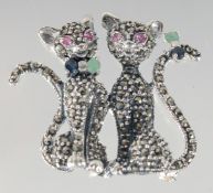 A SILVER MARCASITE RUBY SET CAT BROOCH.