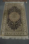 A GOOD PERSIAN DESIGN PART SILK RUG, pale cream and blue ground with stylised floral decoration. 5'