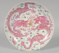 A CHINESE FAMILLE ROSE PORCELAIN DRAGON PLATE, the base with six-character mark, 21cm diameter.