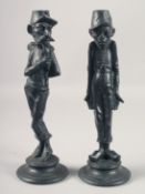 A GOOD PAIR OF 19TH CENTURY FRENCH CARICATURE METAL CANDLESTICKS on circular bases. 13ins high.