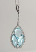 AN 18CT WHITE GOLD BLUE TOPAZ AND DIAMOND PENDANT AND CHAIN.