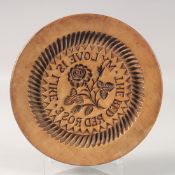 A CIRCULAR TREEN BUTTER STAMP MOLD. The Red Rose. 10ins diameter.