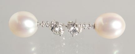A GOOD PAIR OF PEARL AND DIAMOND DROP EARRINGS. 11mm pearls.