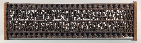 A 19TH CENTURY SOUTH INDIAN CARVED WOODEN PANEL, carved with rows of deities and figures, 97.5cm x