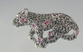 A SILVER RUBY AND MARCASITE PANTHER BROOCH.