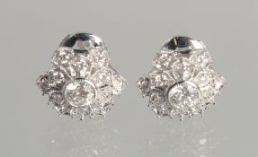 A PAIR OF PLATINUM AND DIAMOND SNOW FLAKE EAR STUDS.