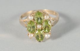 A 9ct. GOLD PERIDOT AND PEARL RING.