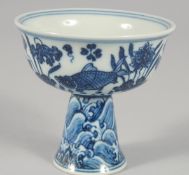 A SMALL CHINESE BLUE AND WHITE PORCELAIN STEM CUP, painted with fish and lotus, interior centre with