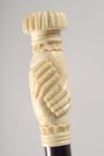 A WALKING STICK WITH CARVED BONE HANDLE modelled as clasped hands.