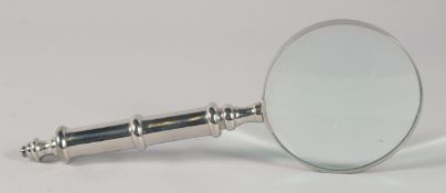 A MAGNIFYING GLASS with chrome handle.