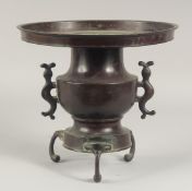 A JAPANESE BRONZE TWIN HANDLE TRIPOD USUBATA VASE, with detachable circular platform, characters