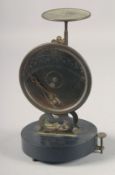 A RARE SET OF EARLY POSTAL SCALES on a circular base. 7ins high.