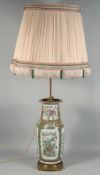 A CHINESE CANTON FAMILLE ROSE PORCELAIN VASE / LAMP, with large shade and mounted to a metal base,