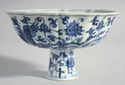 A CHINESE BLUE AND WHITE PETAL SHAPED STEM CUP with lotus and phoenix design. 6ins diameter.