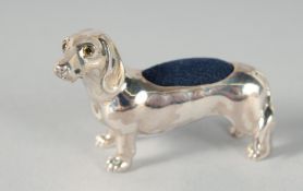 A CAST SILVER DACHSHUND PIN CUSHION. 4.5cm
