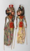 A PAIR OF BALINESE CARVED WOOD FOLK ART PUPPETS, carved figures approx. 57cm long.