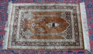 A SMALL PERSIAN SILK PRAYER RUG, brown ground with temple arch and hanging lantern. 3'1