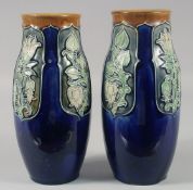 A PAIR OF ROYAL DOULTON STONEWARE BLUE FLORAL VASES. 9ins high.
