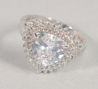 A DECORATIVE SILVER AND CZ RING.