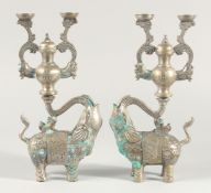 A PAIR OF METAL ELEPHANT FORM CANDLESTICKS, 31cm high.