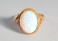 A SILVER 18ct. GOLD-PLATED OVAL OPAL RING.
