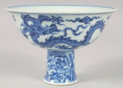 A CHINESE BLUE AND WHITE PORCELAIN STEM CUP, the exterior decorated with dragons, the interior