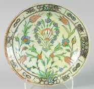 A FINE EARLY 17TH CENTURY OTTOMAN TURKISH IZNIK DISH, painted with central floral spray, 31cm